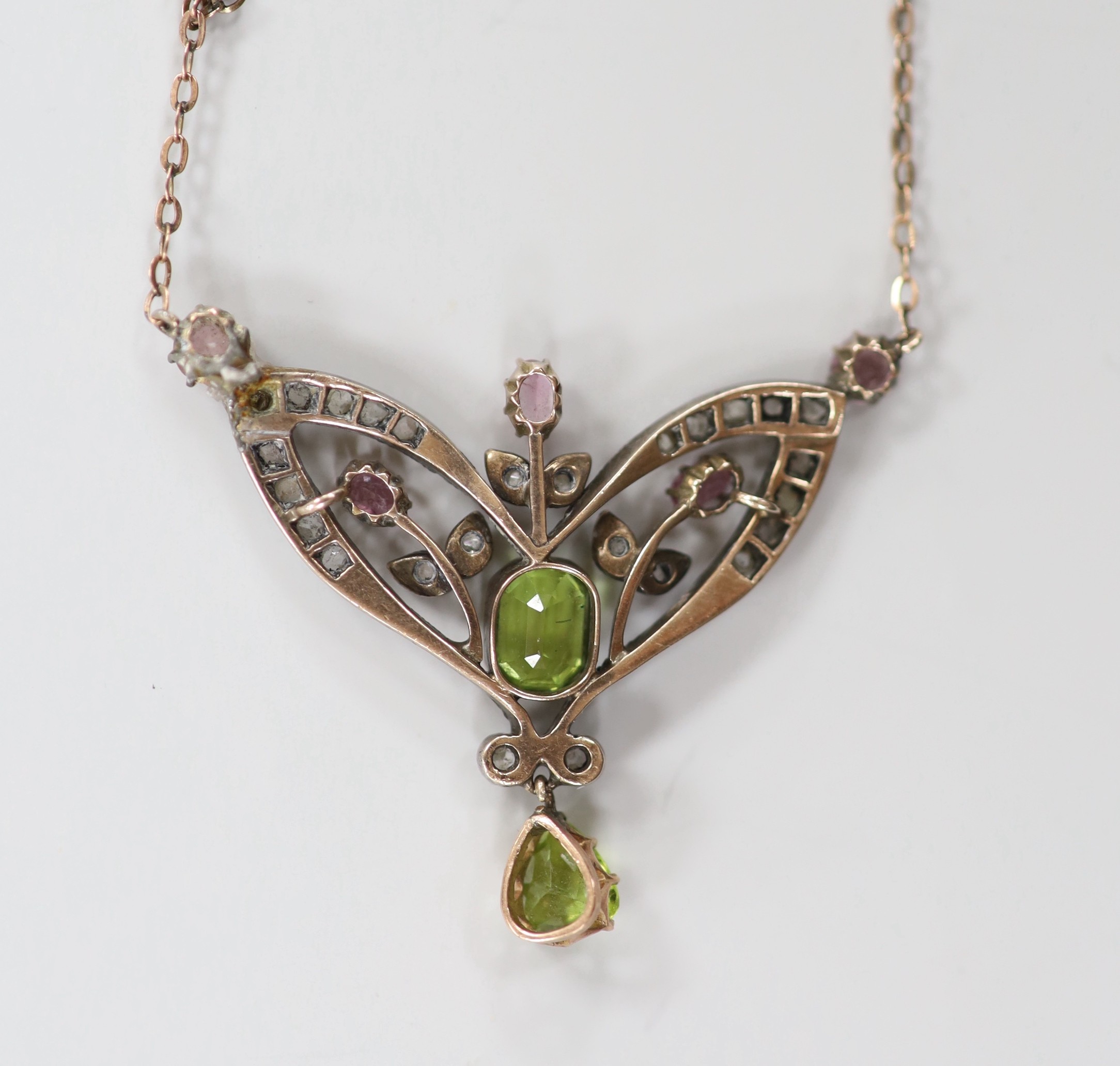 A late Victorian 9ct and white metal. peridot, pink topaz? and rose cut diamond set pendant necklace (a.f.), pendant width 44mm, chain length approx. 34cm, gross weight 7.2 grams.
